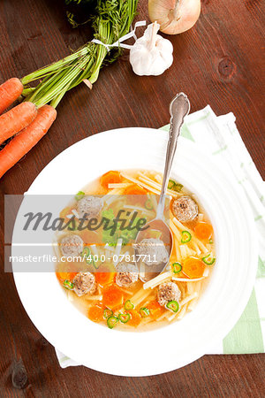 Delicious seasonal homemade vegetable soup with fresh vegetable in background. Healthy eating.