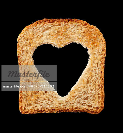Food and health concept - bread slice with heart shaped hole - isolated on black