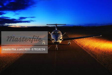 Single turboprop aircraft on the groun, night