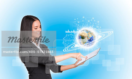 Beautiful businesswomen in suit using digital tablet. Earth with graphs, network and rectangles. Element of this image furnished by NASA
