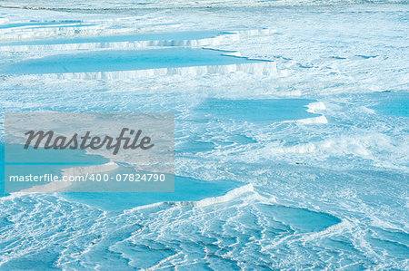 Blue pools and white travertine terraces at Pamukkale, Turkey