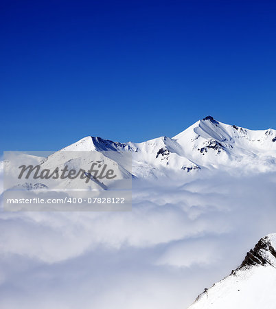 Mountains in clouds at nice day. View from ski slope. Caucasus Mountains, Georgia, Gudauri.
