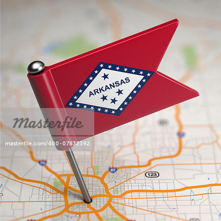 Small Flag of Arkansas on a Map Background with Selective Focus.