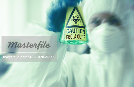 Scientist in protective suit holding beaker with caution sticker