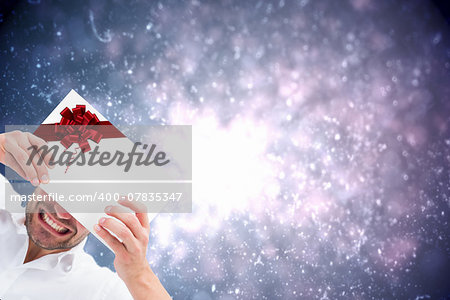 Festive man holding christmas gift with red christmas ribbon