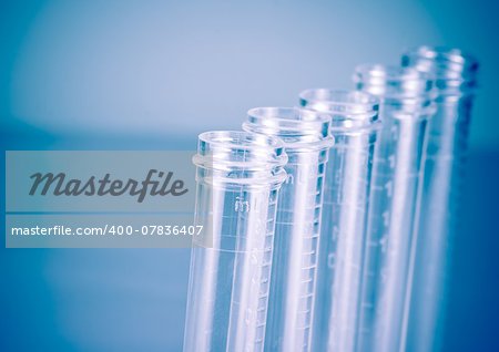 detail of the test tubes in laboratory on blue light tint background with space for text