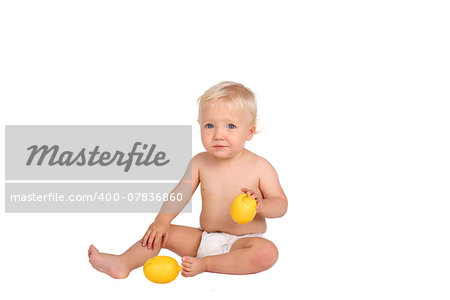 One year old boy with lemon on white background