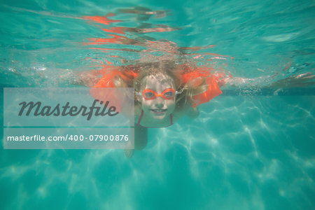 Cute kid posing underwater in pool at the leisure center