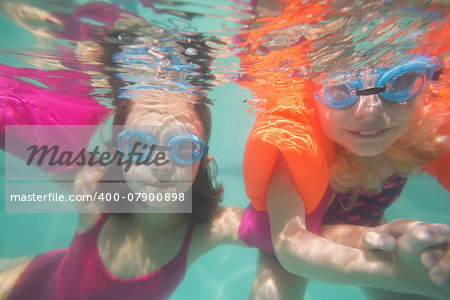 Cute kids posing underwater in pool at the leisure center