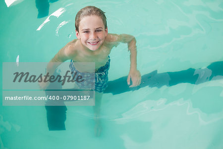 Little boy swimming in the pool at the leisure center