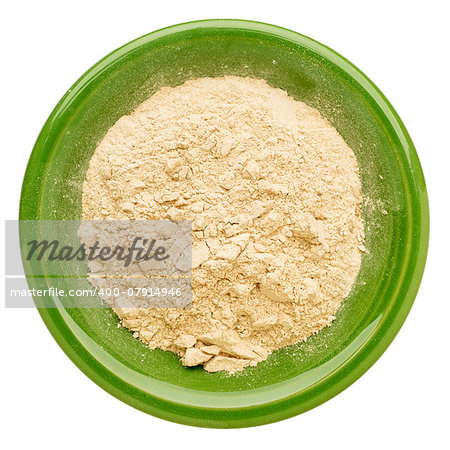 maca root powder in an isolated green ceramic bowl