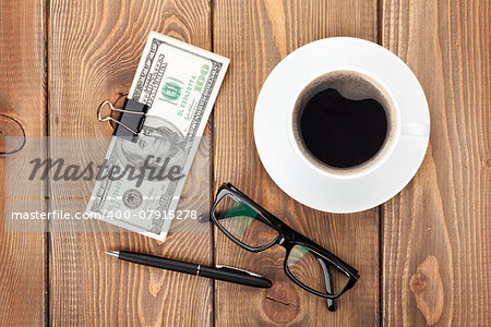 Money cash, glasses, pen and coffee cup on wooden table