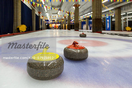 Curling stone on ice of a indoors rink