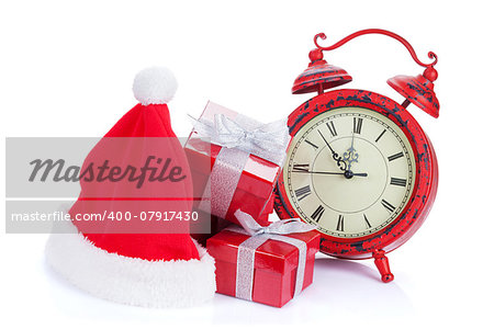 Christmas clock, gift boxes and santa hat. Isolated on white background