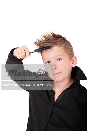 Charming boy with hairbrush and modern cool haircut isolated on white background.