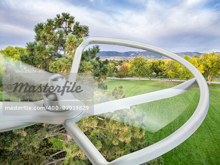 a spinning rotor of a small drone helicopter flying over park