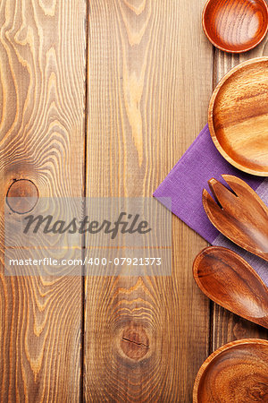 Wood kitchen utensils over wooden table background with copy space