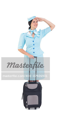 Pretty air hostess holding suitcase on white background