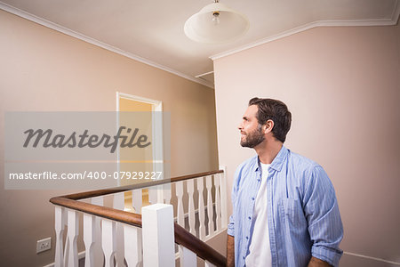 Casual man walking up the stairs in his new home
