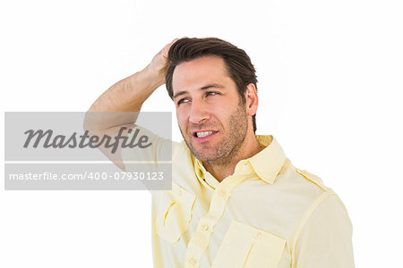 Thinking man posing with hand behind head on white background