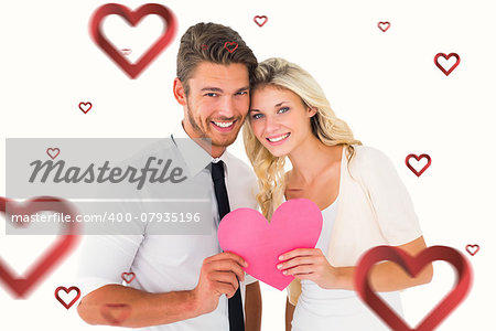 Attractive young couple holding pink heart against hearts