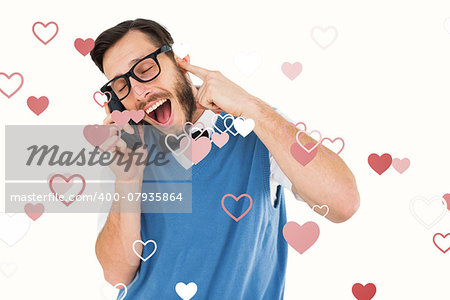 Geeky hipster talking on a retro cellphone against valentines heart design
