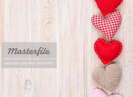 Valentines day background with toy hearts over white wooden table