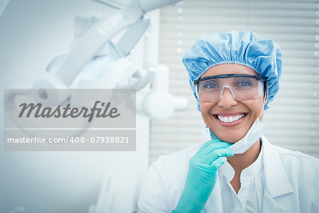 Portrait of female dentist wearing surgical cap and safety glasses