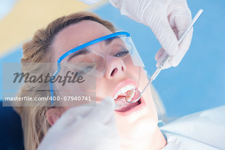 Close up of a patient with mouth open under the light at the dental clinic