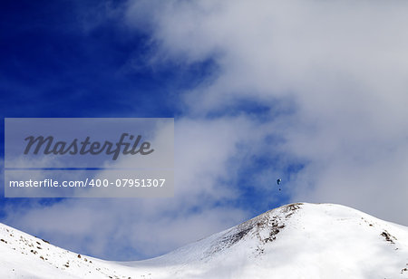 Paraglider silhouette of mountains in windy sky. Caucasus Mountains. Georgia, ski resort Gudauri.