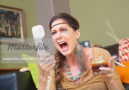 Angry smoker with drink yelling into telephone