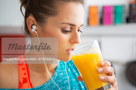 Fitness young woman drinking pumpkin smoothie