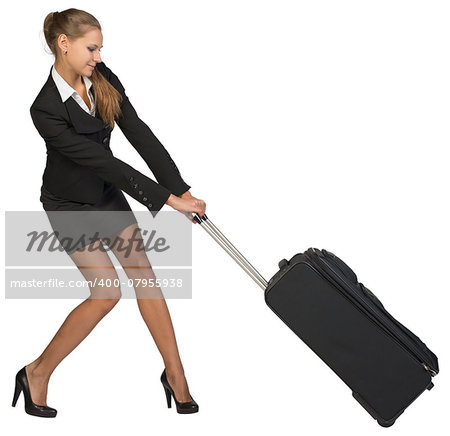 Businesswoman dragging heavy wheeled suitcase with both hands. Isolated over white background