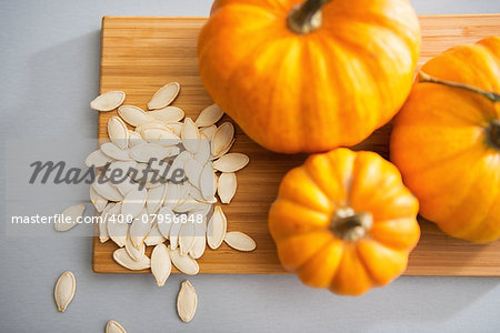 Closeup on small pumpkins and seeds on table