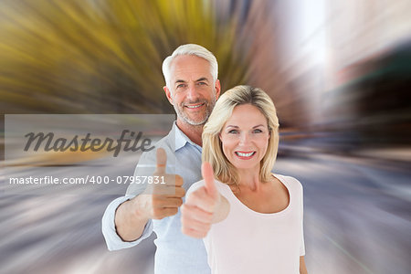 Smiling couple showing thumbs up together against blurry new york street