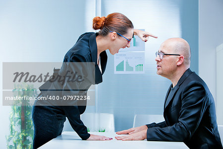 business woman shouting against a business man or a male office worker