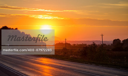 Orange sunset over asphalt road. Horisontal photo