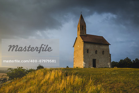 Old Roman Catholic Church of St. Michael the Archangel on the Hill at Sunset in Drazovce, Slovakia