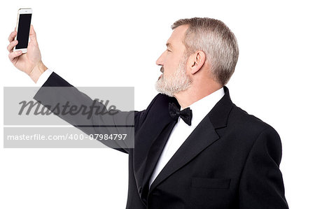 Senior businessman taking a picture of himself