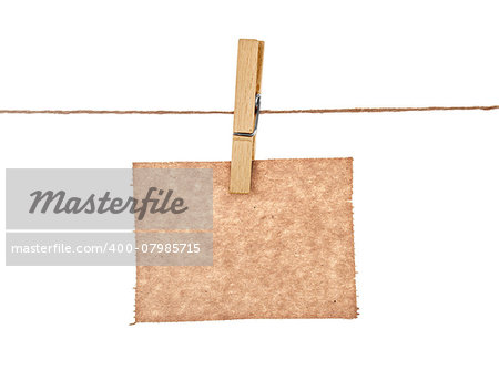 sheet of kraft paper hanging on a rope with clothespin on a white background