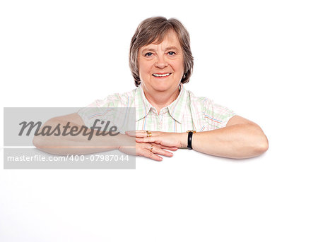 Aged woman standing behind blank billboard. All on white background