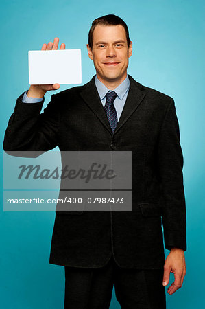 Isolated corporate man holding blank placard, showing it to camera