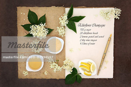Elderflower champagne ingredients with old pen over natural hemp notebook and lokta paper background. Ingredient list included.