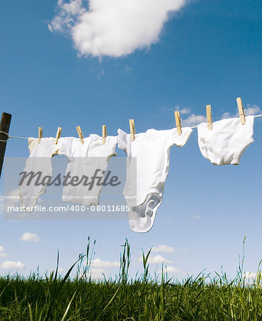 Baby Clothing on a clothesline towards blue sky