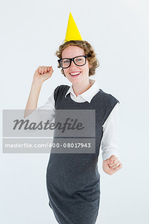 Geeky hipster wearing a party hat on white background