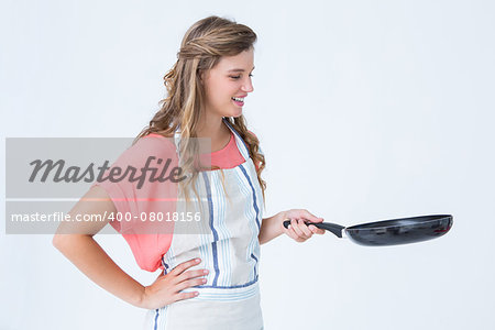 Happy hipster woman holding frying pan on white background
