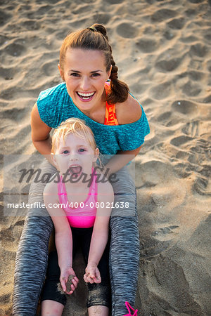 Portrait of healthy mother and baby girl on beach