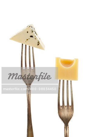 Emmentaler and blue cheese pieces on fork isolated on white background. Culinary cheese background.