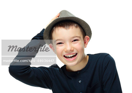 Happy boy clothing a hat with hand on his head on white background