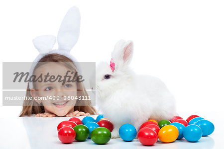 Happy little girl with her easter bunny - smiling and enjoying the magic, isolated